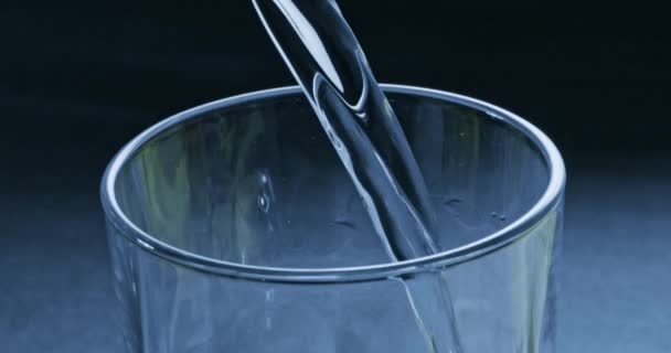 Sauberes Wasser Das Glas Auf Blauem Hintergrund Gegossen Wird — Stockvideo