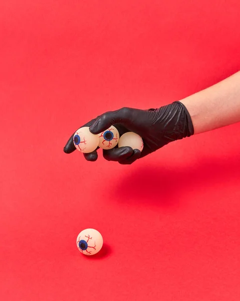 Woman Hand Black Glove Holds Human Eyeballs Red Background Copy — Stock Photo, Image