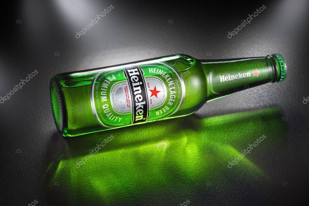 UKRAINE, KYIV - APRIL 02, 2014. Bottles of Heineken Lager Beer with green reflaction, the flagship product of Heineken International which owns over 125 breweries in more than 70 countries.
