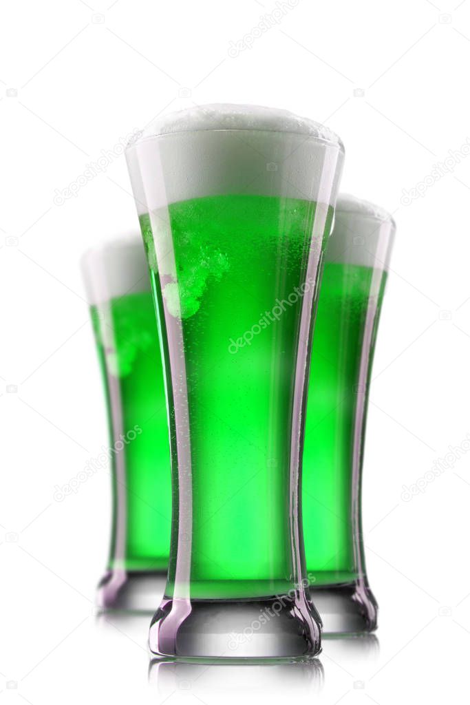 Fresh natural green beverage beer with thick foam in the glasses on a white background, copy space. Happy St.Patrick 's Day concept.