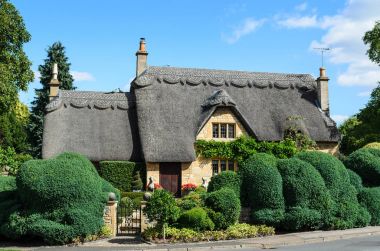 Thatched cottage with beautiful garden clipart