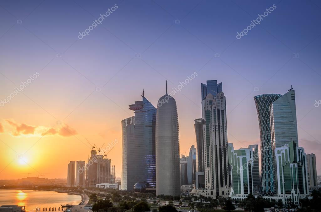 The skyscrapers in the skyline of the commercial center of Doha, the capital of the Arabian Gulf country Qatar at sunset.