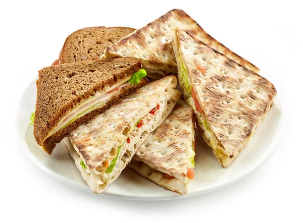 Plate of various triangle sandwiches — ストック写真