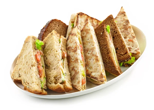 Plate of various triangle sandwiches — ストック写真