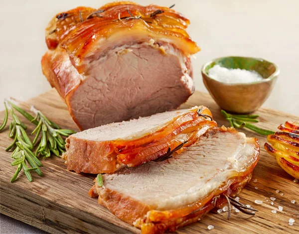 Roasted pork on wooden cutting board — Stock Photo, Image