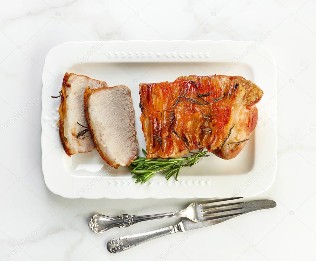sliced roasted pork on white plate