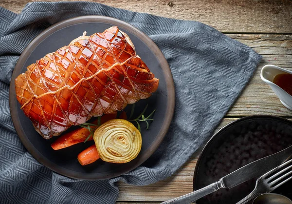 Roasted pork on wooden table — Stock Photo, Image