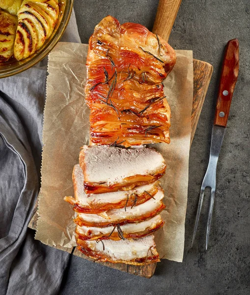 Roasted pork on wooden cutting board — Stock Photo, Image