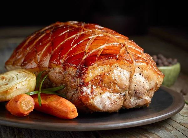 Roasted pork on dark plate — Stock Photo, Image