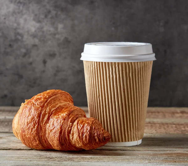 Paper coffee cup and croissant — Stock Photo, Image