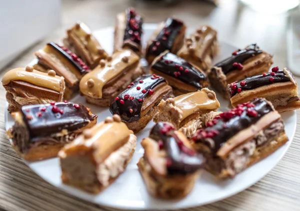 Teller mit Eclairs — Stockfoto