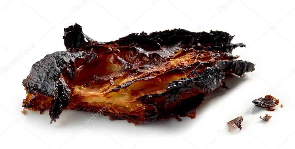 burned croissant on a white background