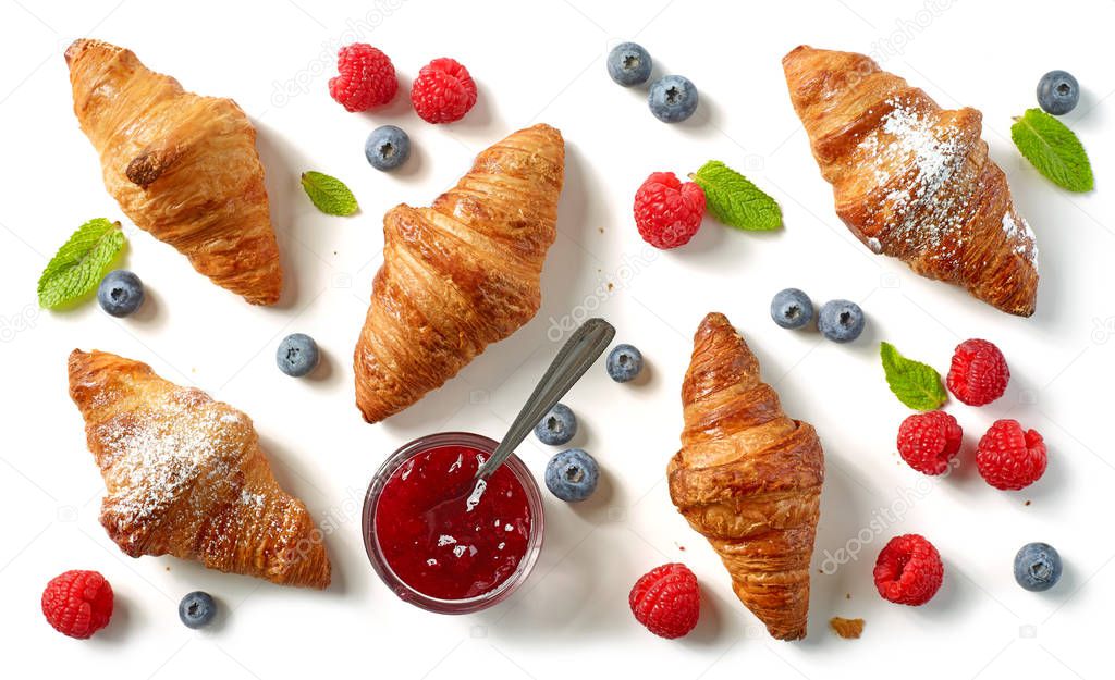 freshly baked croissants on white background, top view