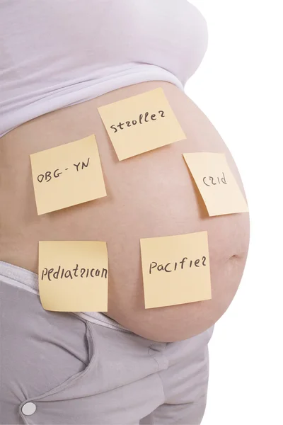 Těhotné břicho a nálepka poznámky (Ořezová cesta) — Stock fotografie
