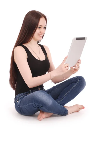 Happy student teenage girl sitting sideways on the floor with ta — Stock Photo, Image