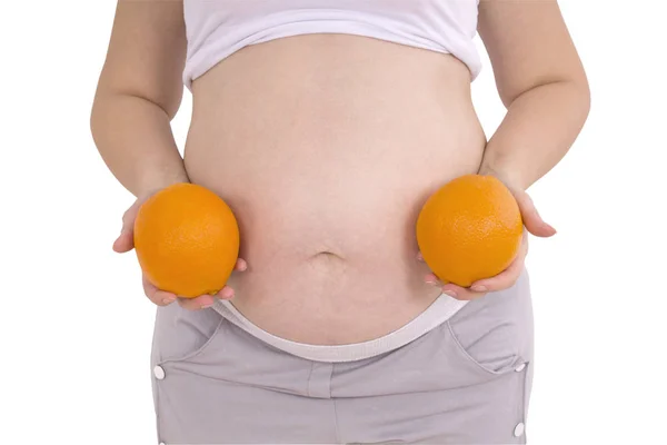 Gravid kvinna med orange (urklippsbana) — Stockfoto