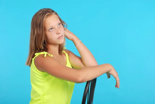 Smiling girl sits on a chair isolated — Stock Photo, Image