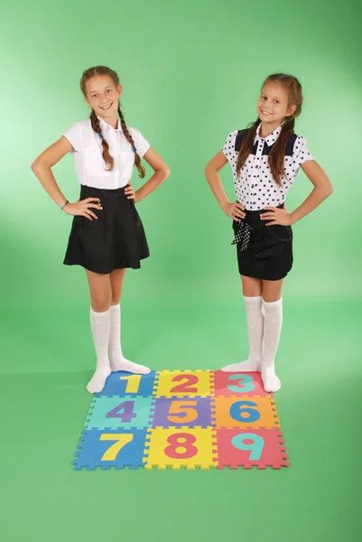Two girls on rug with numbers — Stock Photo, Image