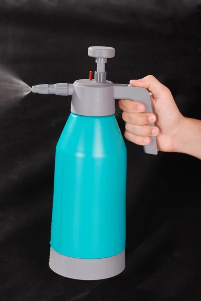 Male hand holding spray bottle — Stock Photo, Image
