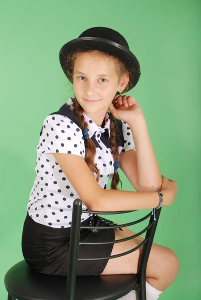 Beautiful young girl in black  hat on his head — Stock Photo, Image