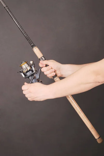 Hand holding a fishing rod — Stock Photo, Image