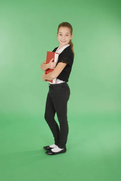 Chica de la escuela joven con libro rojo —  Fotos de Stock