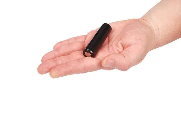 Рука держит черный аккумулятор (вырезка пути ) — стоковое фото