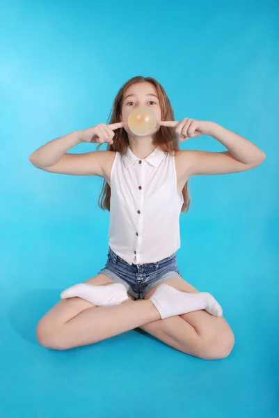Молода дівчина робить велику бульбашку з жувальною гумкою — стокове фото