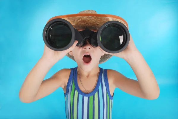 Curious boy looking through binoculars — Stock Photo, Image