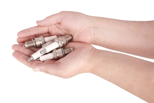 Four spark plugs in the open palms (Clipping path) — Stock Photo, Image