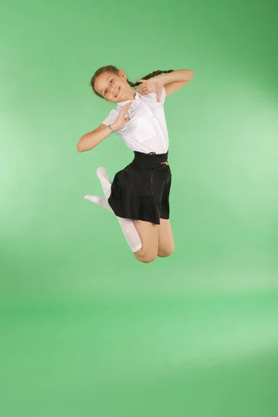 Cute happy school girl jumping — Stock Photo, Image