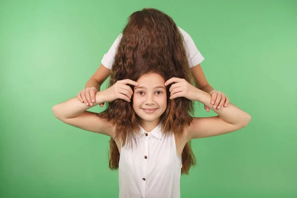 Retrato divertido de dos chicas jóvenes con el pelo largo —  Fotos de Stock