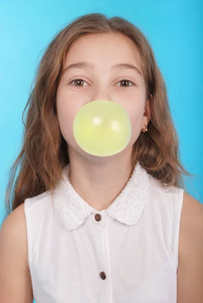 Chica joven haciendo una gran burbuja con un chicle — Foto de Stock