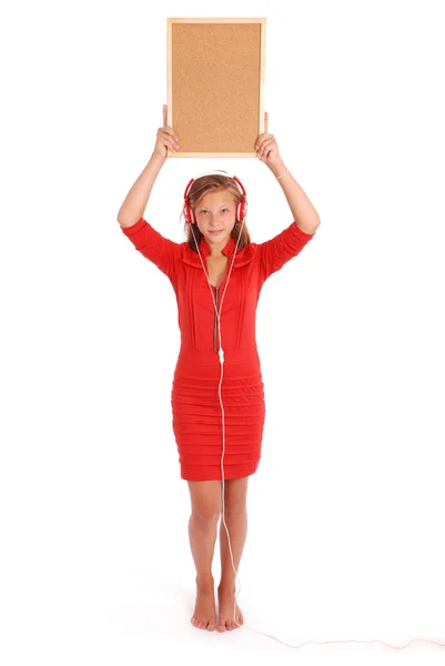 Dospívající dívka v sluchátka, drží korkové desky — Stock fotografie