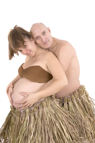 Man and pregnant woman in a dress made from straw — Stock Photo, Image