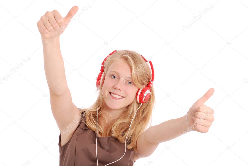 Pretty teenage girl listening music on her headphones