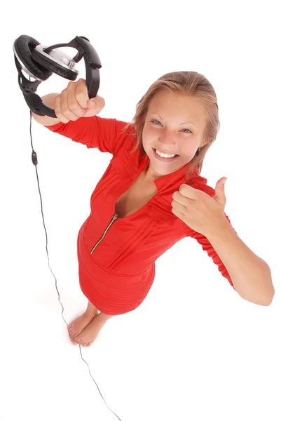 Chica encantadora escuchando una música con auriculares —  Fotos de Stock