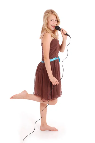 Happy young beautiful girl singing with microphone — Stock Photo, Image
