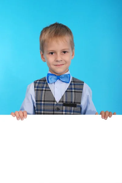 Schoolboy holding a white banner — Stock Photo, Image