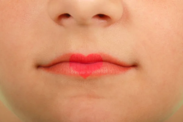 Young beautiful girl playing with heart drawing on lips — Stock Photo, Image