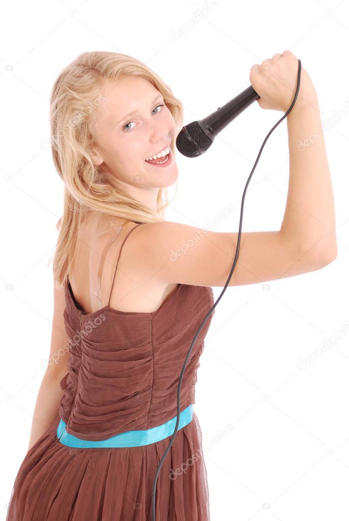 Happy young beautiful girl singing with microphone