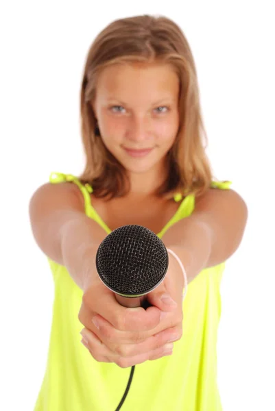 Teenage girl holding a microphone in front — Stock Photo, Image