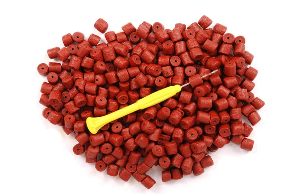 Pellet de alabote pré-perfurado vermelho — Fotografia de Stock