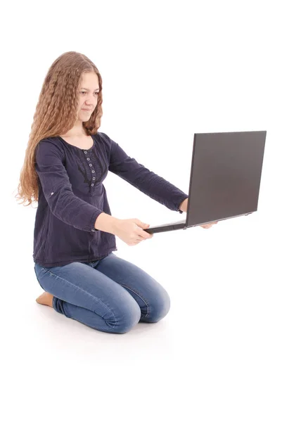 Student teenage girl sitting sideways on the floor with laptop — Stock Photo, Image