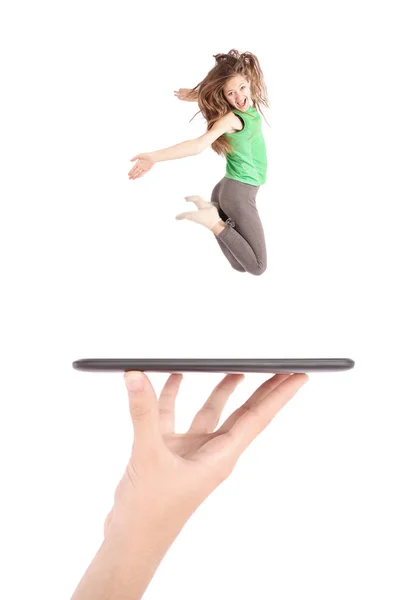 어린 소녀 점프 사람들 손에 태블릿 pc를 사용 하 여 — 스톡 사진