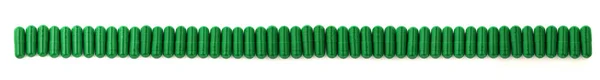 Green capsules standing in a row — Stock Photo, Image