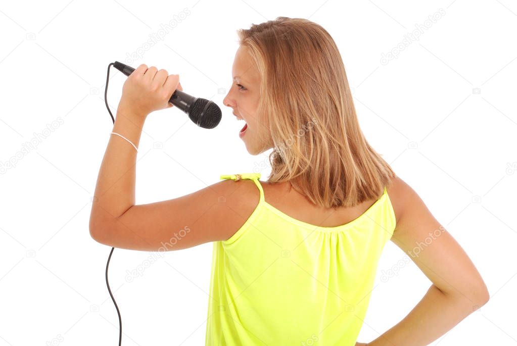 Happy young beautiful girl singing with microphone