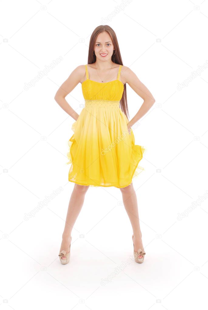 Teenage girl is standing back yellow dress.