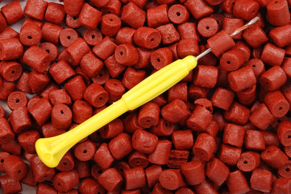 Red pre-drilled halibut pellet — Stock Photo, Image