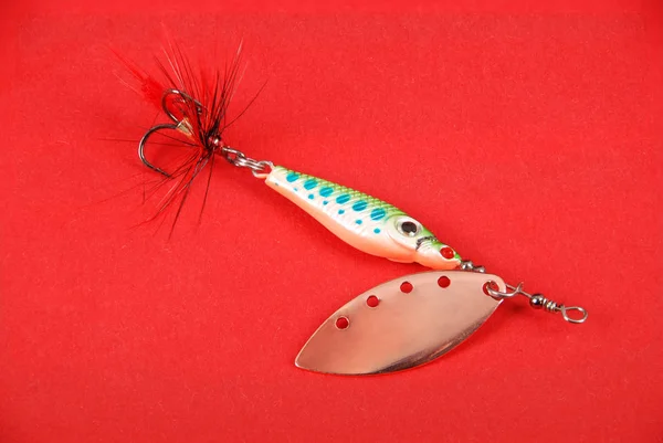 Fishing lure on red background — Stock Photo, Image